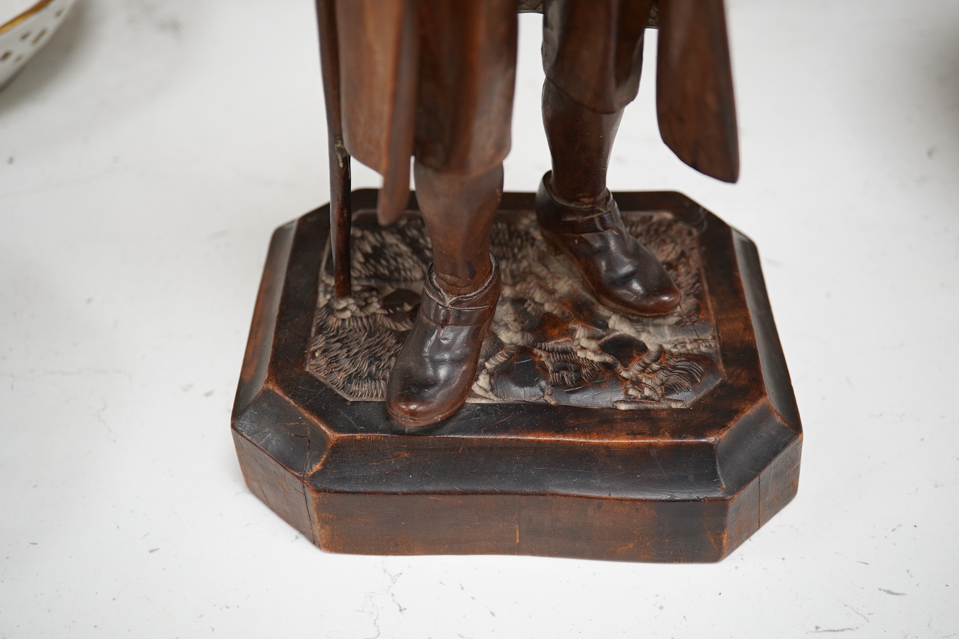 A 19th century Black Forest figure of a gentleman smoking a pipe, hinged at the waist to hold tobacco?, 36.5cm high. Condition - poor to fair, the shaft of his pipe is missing and the rear section of his hat